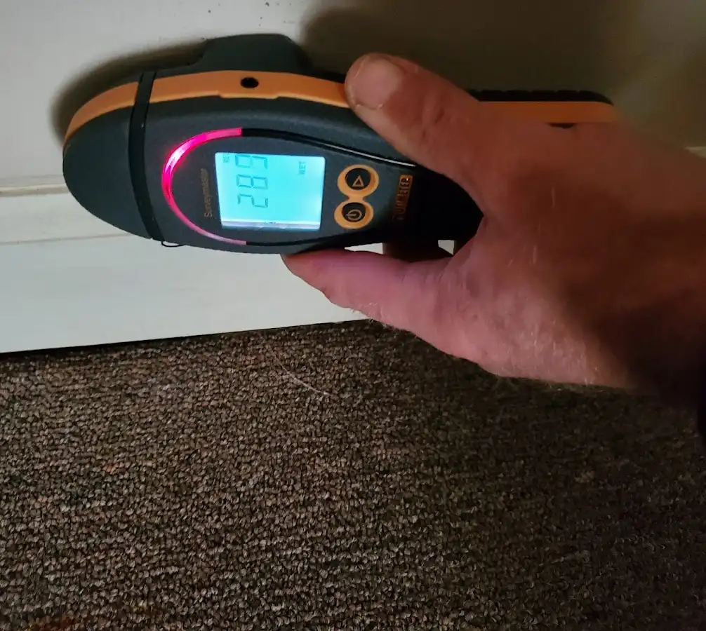 Moisture detection at baseboard during Storm Damage Restoration in Stuart